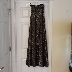 Black lace strapless prom or evening dress.